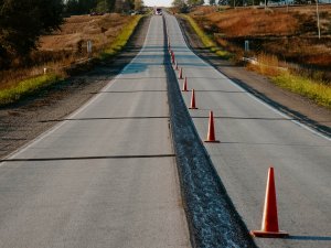 A photo of a stretch of road that has been leveled using slurry leveling.